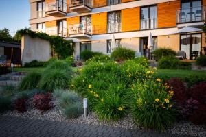 a garden in front of a building with flowers at Hotel Uniejów in Uniejow +60 photos