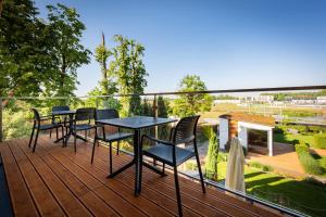 a deck with chairs and a table on a balcony at Hotel Uniejów in Uniejow