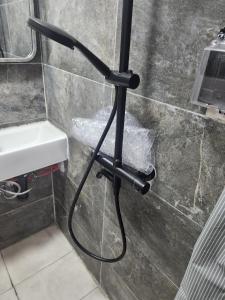 a black pole in a bathroom with a sink at Respite room in Chambly +14 photos