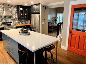 a kitchen with a white counter and a red door at BoCo Bungalow in Superior