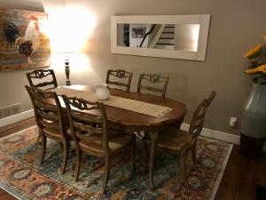 a dining room with a wooden table and chairs at BoCo Bungalow in Superior