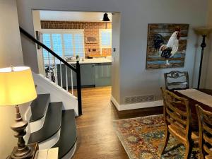 a kitchen and dining room with a chicken painting on the wall at BoCo Bungalow in Superior