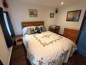 a bedroom with a large bed with a white comforter at The Captains in Bettyhill