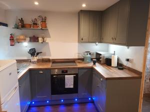 a kitchen with blue led lights on the counters at The Captains in Bettyhill