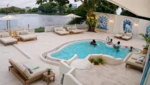 a group of people playing in a swimming pool at The Tranquilite' in Anuradhapura