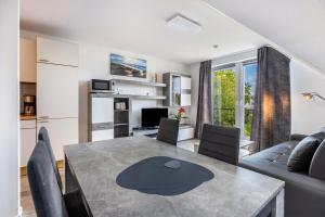 a kitchen and living room with a table and chairs at Luv Lee Duhnen 06 in Cuxhaven