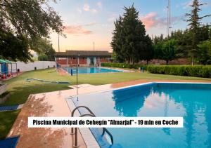 a large swimming pool in a yard with a playground at Ruralux Valentín in Calasparra