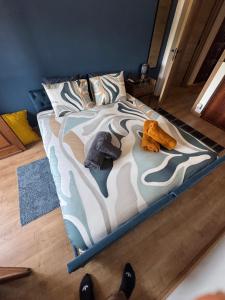a bed with two stuffed animals on it in a room at Margem Rio Residence in Sacavém +11 photos
