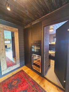a tiny house with a stove in a room at Beautiful apartment in Sinnes E12 in Dirdal