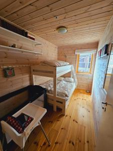 a small room with a bunk bed and a chair at Beautiful apartment in Sinnes E12 in Dirdal