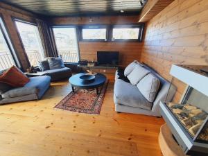 a living room with a couch and a table at Beautiful apartment in Sinnes E12 in Dirdal