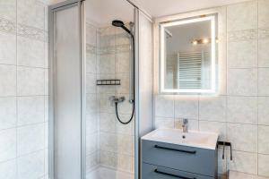 a bathroom with a shower and a sink and a mirror at Ferienwohnung Gipfelblick in Oberau +21 photos