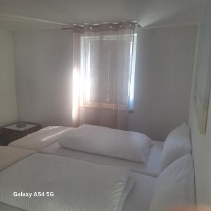 a bedroom with two beds and a window at Gasthaus Sonne 3 in Braunsbach
