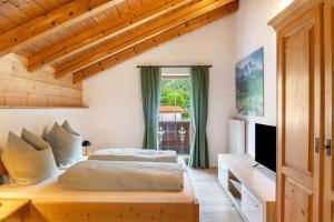 a bedroom with a bed and a large window at Ferienwohnung Gipfelblick in Oberau