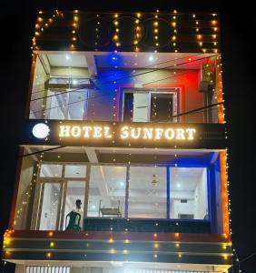 a man standing in the front of a hotel with lights at Hotel SunFort in Rājgīr