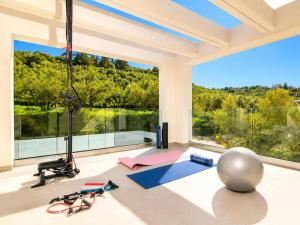 a living room with a large window and a gym at Villa Vatia 3 in Tragaki