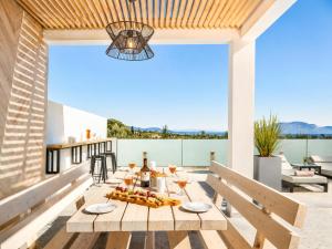a dining table on a patio with a view at Villa Vatia 3 in Tragaki