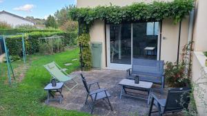 a group of chairs and tables in a yard at L'annexe des Iris in Chaponost