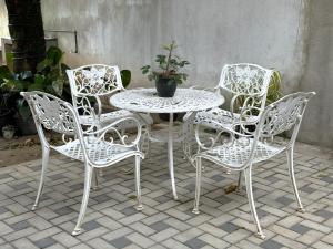 a group of chairs and a table with a potted plant at White House Galaha in Galaha Town