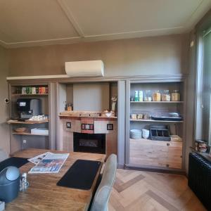 a living room with a table and a kitchen at B&B de Pastorie Terneuzen in Terneuzen