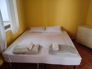 a bed in a room with two towels on it at Nomad Villa Tirana in Tirana