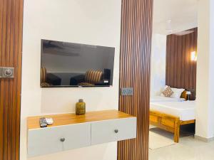 a bedroom with a bed and a desk with a mirror at Secret Gem in Arugam Bay