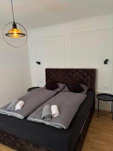 a bedroom with a large bed with two towels on it at Apartmani Daria in Ljubuški