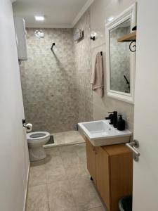 a bathroom with a sink and a toilet at Apartmani Daria in Ljubuški +3 photos