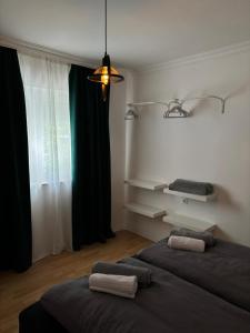 a room with two beds and a window with at Apartmani Daria in Ljubuški
