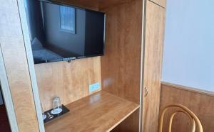 a flat screen tv on a wall in a room at DORMERO Express Hotel Passau in Passau