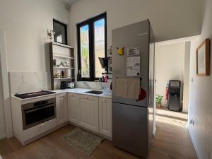 a kitchen with a refrigerator and a sink at Cosy home in Three Cities in Taʼ Penza
