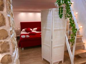 a bedroom with a red bed and a white ladder at Le Chalet Palermo Centro in Palermo