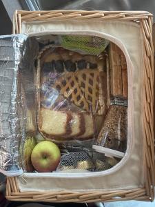a basket full of food with an apple in it at Glamping & Spa Luna Azzurra in Sulmona
