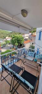 a balcony with two chairs and a couch on it at Sea La Vie in Valun