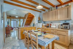 a kitchen with a table and chairs and a kitchen with a table and a kitchen at Le Saint Roch in Villeréal +20 photos