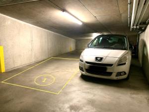 a white car parked in a parking garage at Shanti - Sérénité in Esch-sur-Alzette