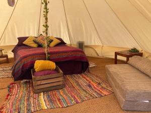 a bedroom with a bed in a tent at Camping at the Barge in Alton Barnes
