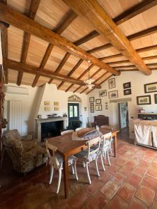 a large living room with a wooden table and chairs at Antico Stazzo Gallurese in Luogosanto