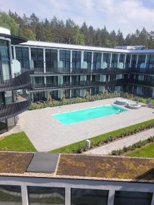 an aerial view of a building with a swimming pool at Amber Elite Apartments in Stegna