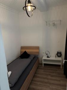 a bedroom with a bed and a white table at Apartmani Daria in Ljubuški