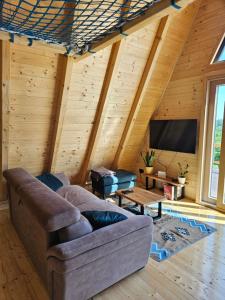 a living room with a couch and a flat screen tv at Moonrise house Rudnik in Rudnik +34 photos
