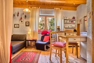 a kitchen and living room with a table and a couch at Grashöfle in Höhenbrunn