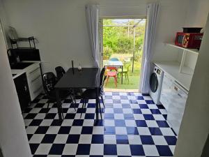 a kitchen with a table and a checkered floor at Villa Boulou in Rognes