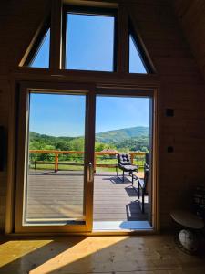 an open door with a view of a deck at Moonrise house Rudnik in Rudnik