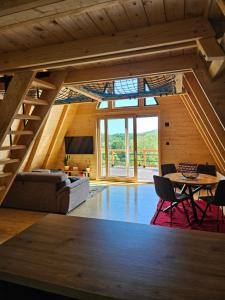 a living room with a staircase and a table at Moonrise house Rudnik in Rudnik