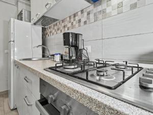 a kitchen with a stove with a coffee maker on it at Konstanzer 44 - Urban Studio - Iulius Mall - AC in Iaşi