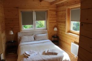 a bedroom with a bed in a log cabin at Chalet Lohr in Lohr