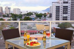 a table topped with plates of food on top of a city street at Cairns Central Plaza Apartment Hotel in Cairns