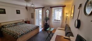 a bedroom with a bed and a couch at Sea La Vie in Valun