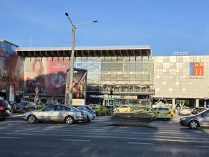 a parking lot with cars parked in front of a building at Konstanzer 44 - Urban Studio - Iulius Mall - AC in Iaşi